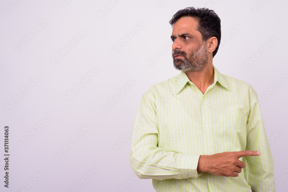 Portrait of mature handsome bearded Indian businessman Portrait of mature handsome bearded Indian businessman