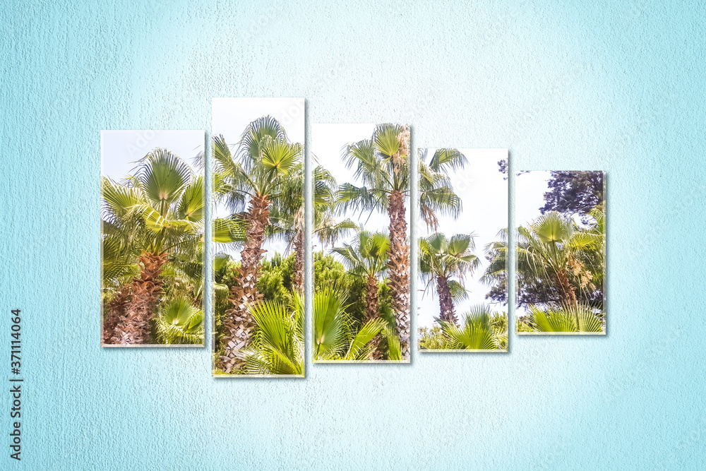 Fototapeta premium Five canvas set isolated on light blue painted wall with palms view posters. Interior decor mock up