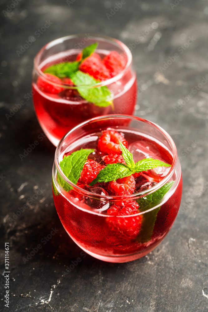 Raspberry and mint cocktail in glass on the rustic background. Selective focus. Shallow depth of field. Raspberry and mint cocktail in glass on the rustic background. Selective focus. Shallow depth of field.