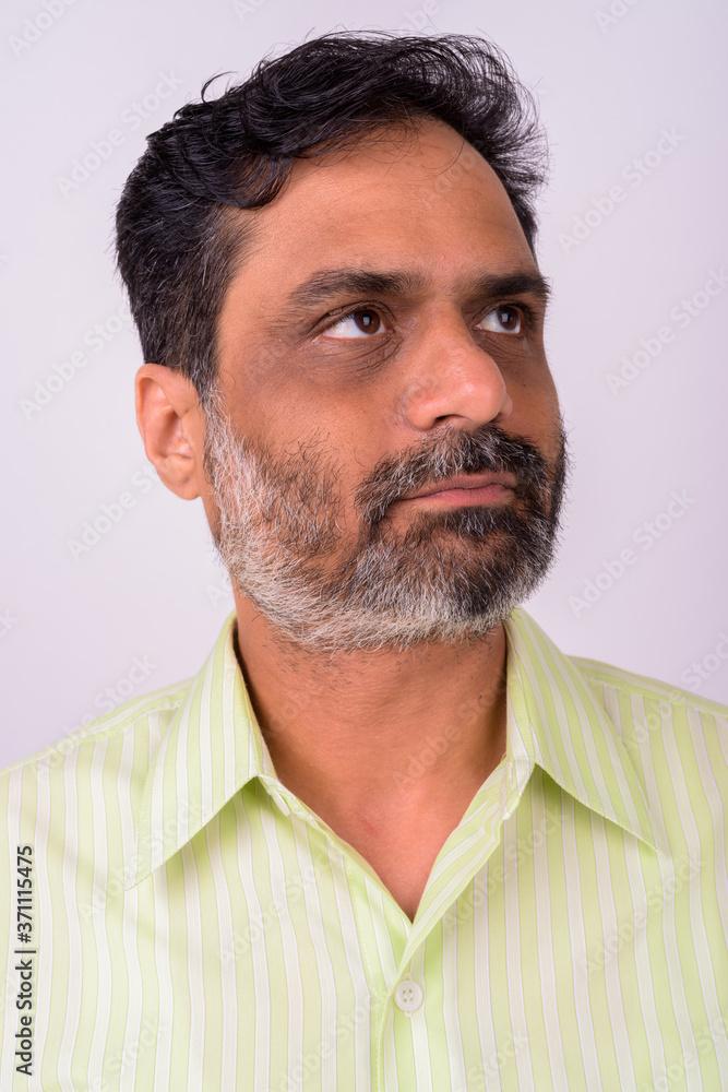 Fototapeta premium Portrait of mature handsome bearded Indian businessman