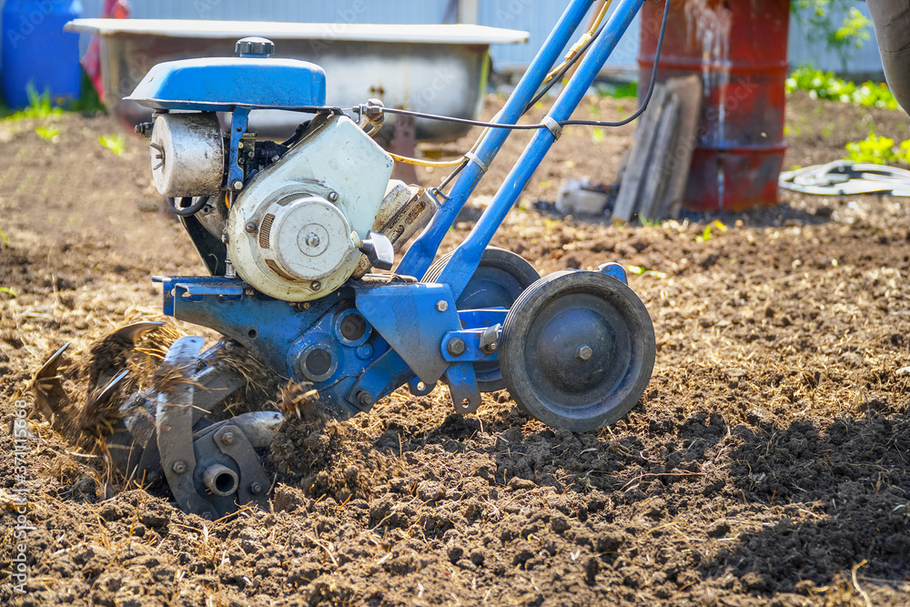 Garden tillers cultivator for tillage. Gardening. Selective focus Garden tillers cultivator for tillage. Gardening. Selective focus