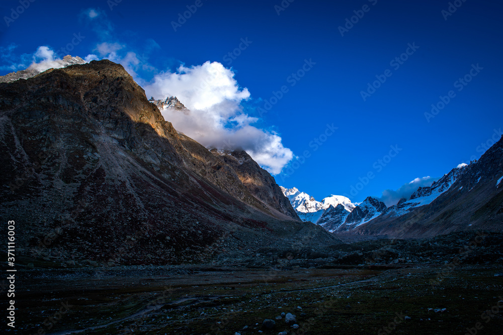 Fototapeta premium View of snowcapped Hamta Pass, the Deseret valley on the Pir Panjal range in the Himalayas. It is a small corridor between Lahaul and Kullu valley of Himachal Pradesh, India.