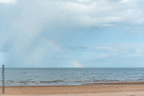 beach and sky with rainbow