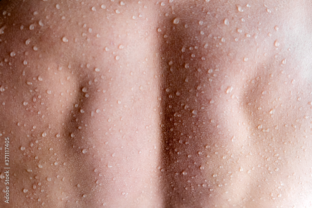 Fototapeta premium Muscular Man back with water drops. Fitnes and healt care concept top horizontal view