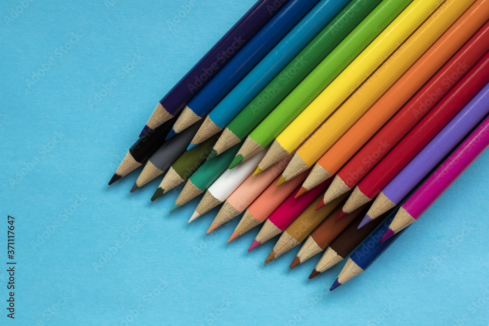 Colored pencils on blue background Colored pencils on blue background