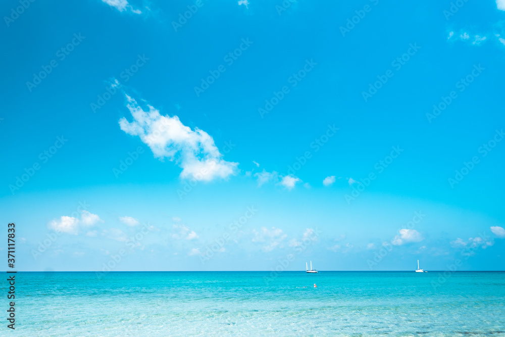 Clear water on the island,Bright blue sea and wooden boat The tourism