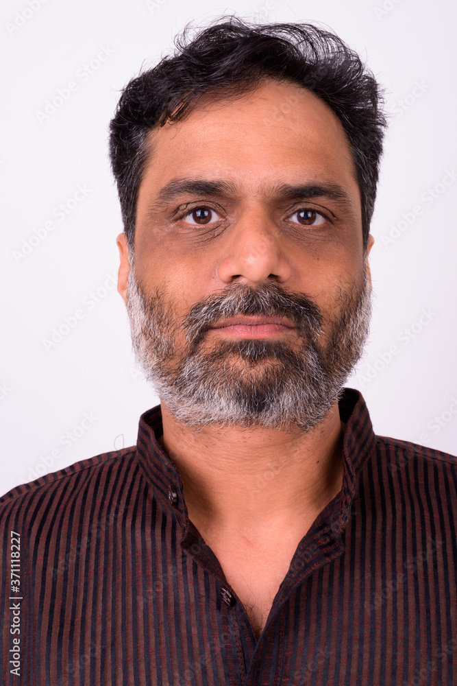Fototapeta premium Portrait of mature handsome bearded Indian businessman