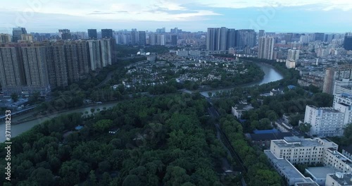 Aerial view of Chengdu City at evening with river flowing through the Wangjiang park  photo