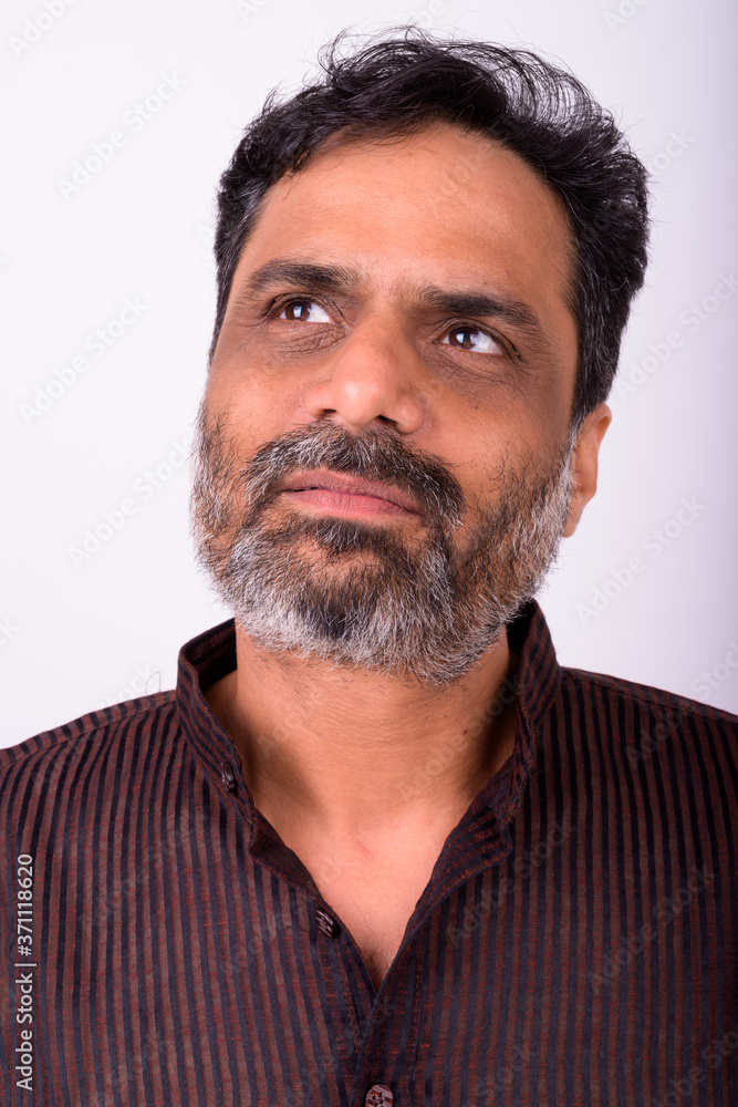 Fototapeta premium Portrait of mature handsome bearded Indian businessman