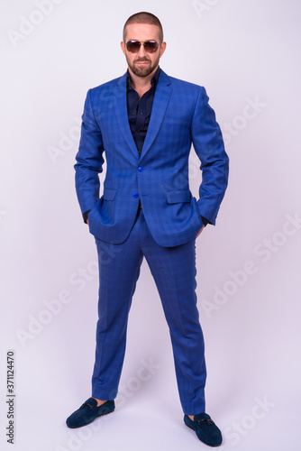 Portrait of handsome bald bearded businessman in suit © Ranta Images