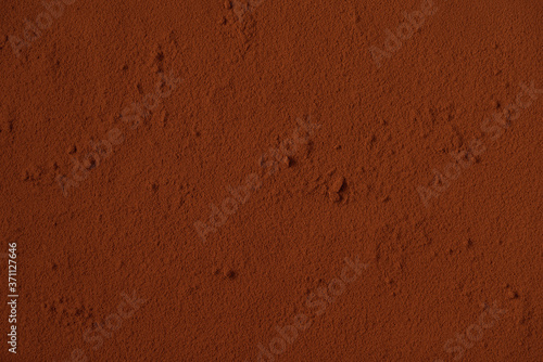Table surface covered with cocoa powder. Background. Space for text. Copy space. © Grigoriy