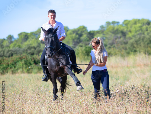 riding teenager, teacher and horse © cynoclub