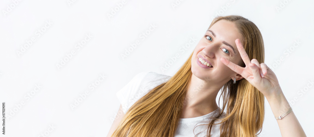 Portrait of a cute girl happily showing the peace victory gesture how to fool around being an optimist. Hey, smile.