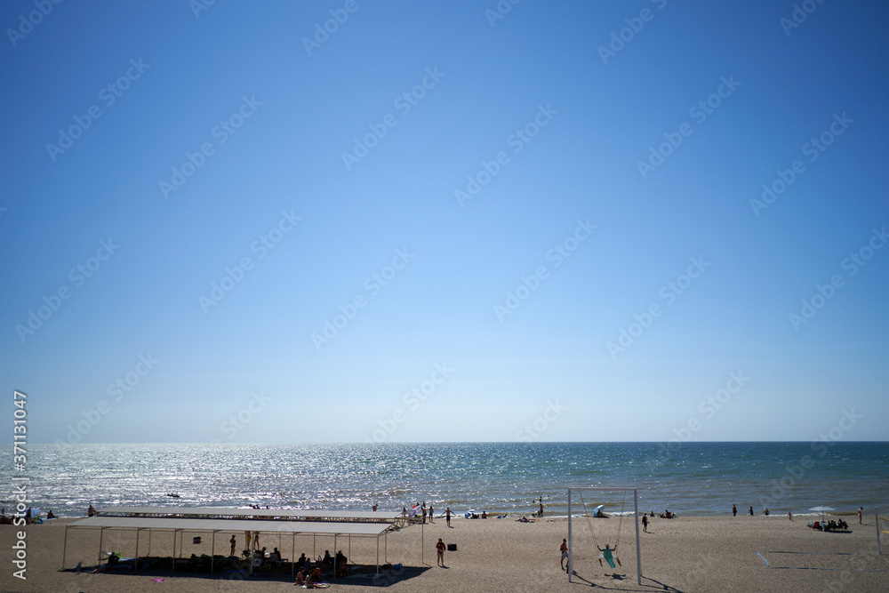 Fototapeta premium people sunbathe by the sea