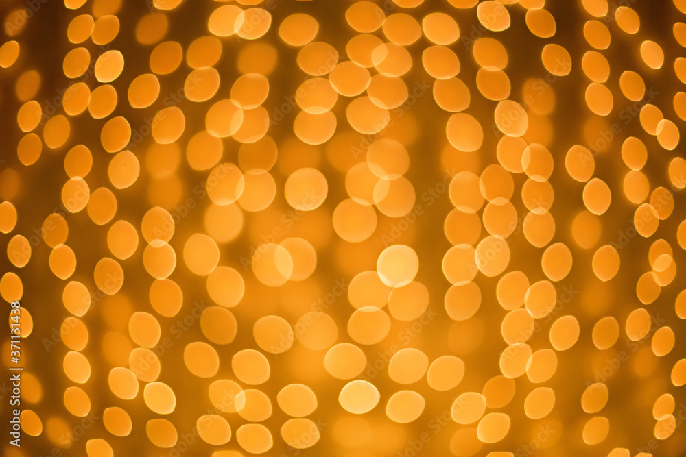 Bright Golden bokeh on the background of Christmas trees and garlands background. New year and Christmas Bright Golden bokeh on the background of Christmas trees and garlands background. New year and Christmas