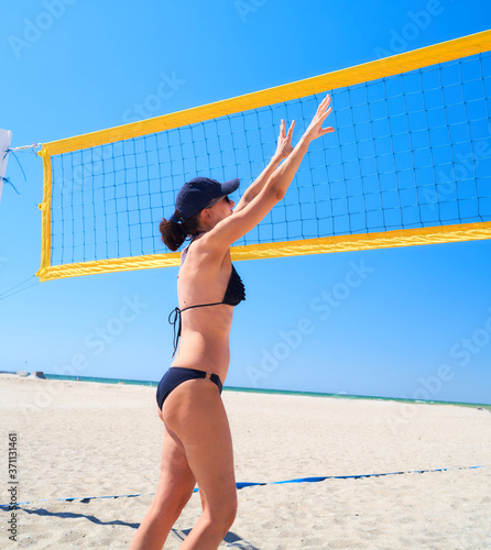 girl playing beach volleyball on the seashore