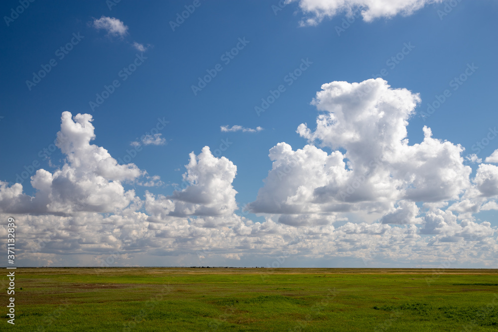 Cumulus clouds over the green Kazakh steppe. Cumulus clouds over the green Kazakh steppe.