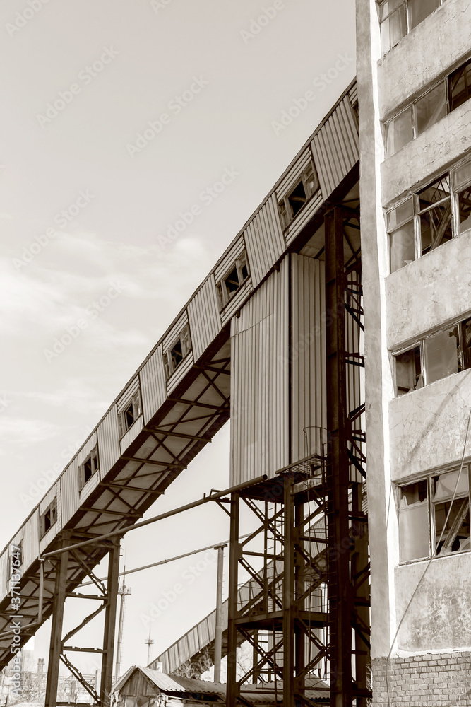 Old, abandoned concrete plant with iron rusty tanks and metal structures. The crisis, the fall of the economy, stop production capacity led to the collapse. Global catastrophe. Old photo effect Old, abandoned concrete plant with iron rusty tanks and metal structures. The crisis, the fall of the economy, stop production capacity led to the collapse. Global catastrophe. Old photo effect