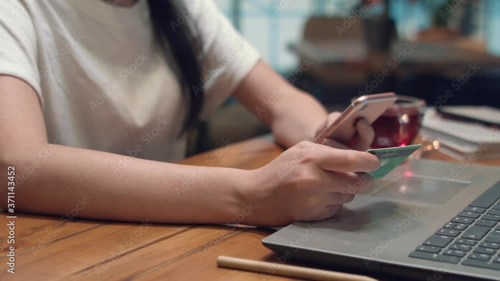 Online banking with a smartphone. Lifestyle. Easy pay using a smartphon or digital device. Communication via app for sale in shop. Women shopping online on a sunny day with credit card. Hands close up Online banking with a smartphone. Lifestyle. Easy pay using a smartphon or digital device. Communication via app for sale in shop. Women shopping online on a sunny day with credit card. Hands close up