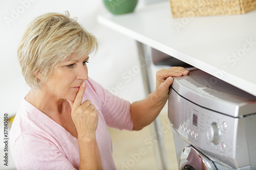 lady using a wasching machine photo