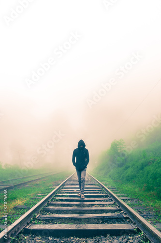 man on railroad tracks
