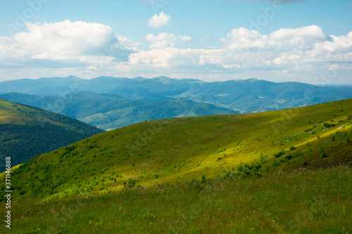 summer landscape of runa mountain. grassy hills of alpine meadow  polonyna . beautiful destination of ukrainian carpathians. clouds on the sky