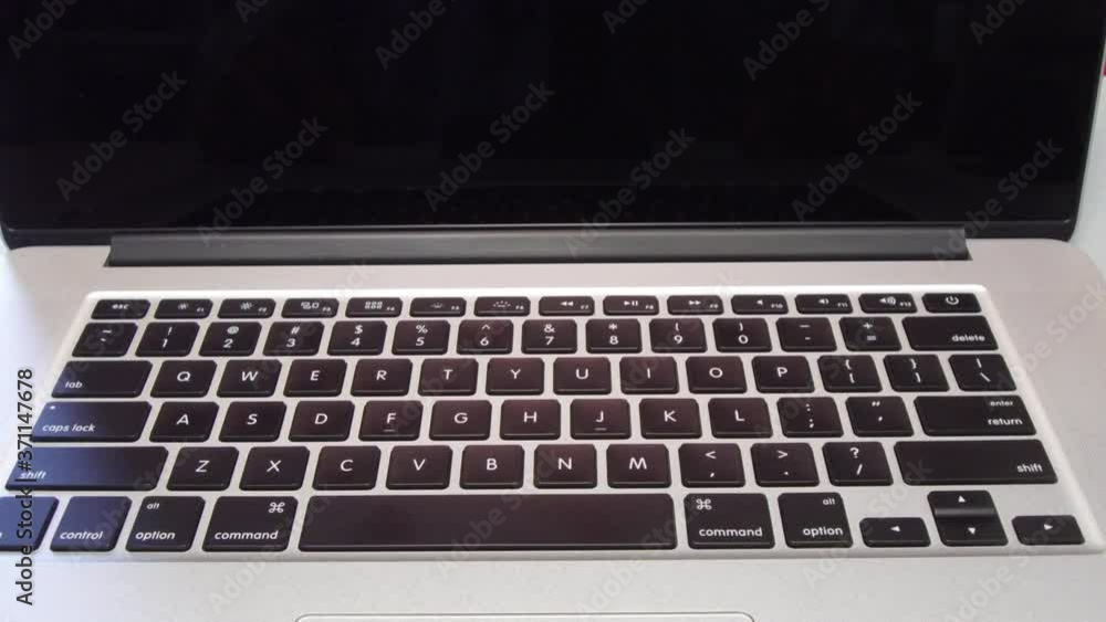 Man Typing the Letter Y Key on Laptop Computer Man Typing the Letter Y Key on Laptop Computer