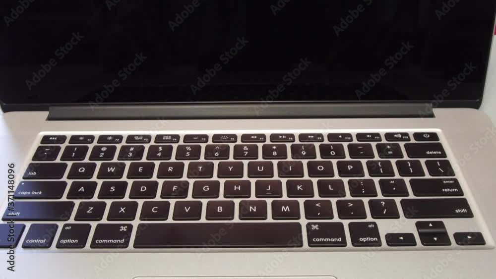 Man Typing the Option Key on Laptop Computer Man Typing the Option Key on Laptop Computer
