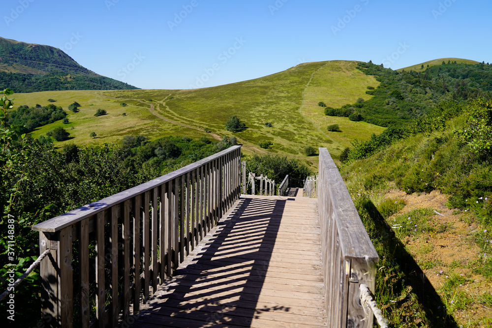wooden bridge access to the Puy de Dôme volcano mountain on Puy Pariou in Auvergne french