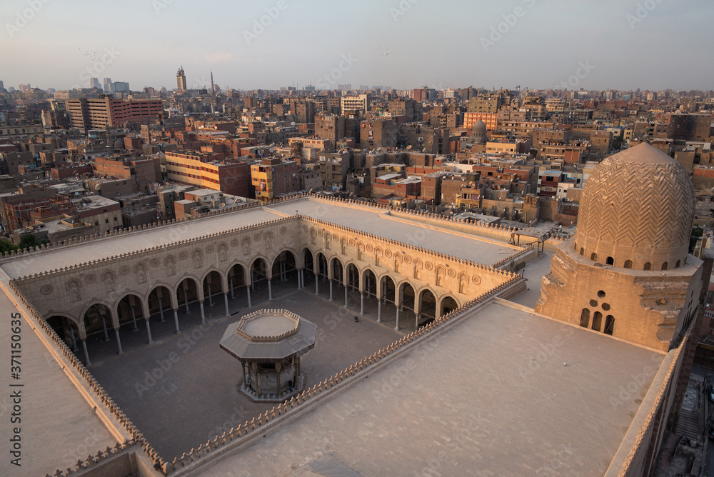 Elevated image from Bab Zuwayla of downtown Cairo with old ocher buildings and mosque courtyard
