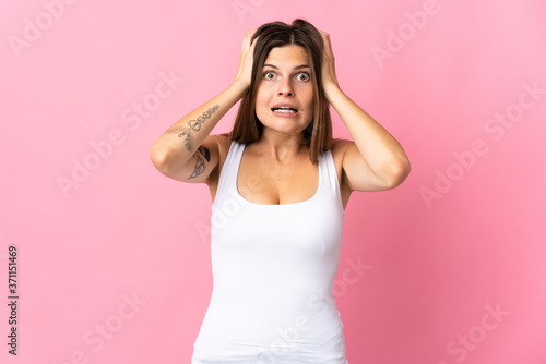 Young slovak woman isolated on pink background doing nervous gesture