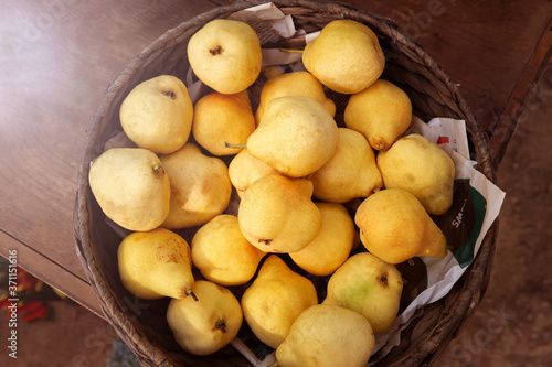 Ripe yellow pears in a wicker basket.