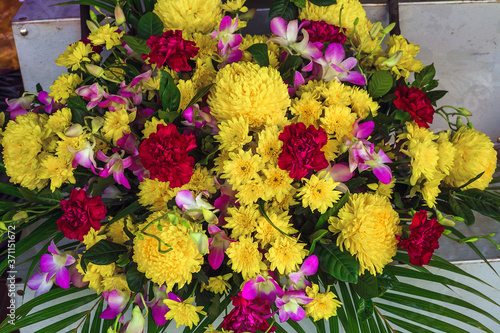 Fototapeta Naklejka Na Ścianę i Meble -  Bright bouquet of pink orchids, yellow chrysanthemums and asters