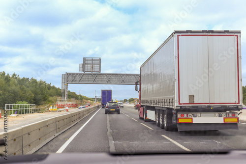 Transport cargo truck travelling down a busy road the lorry has no logo © tommoh29