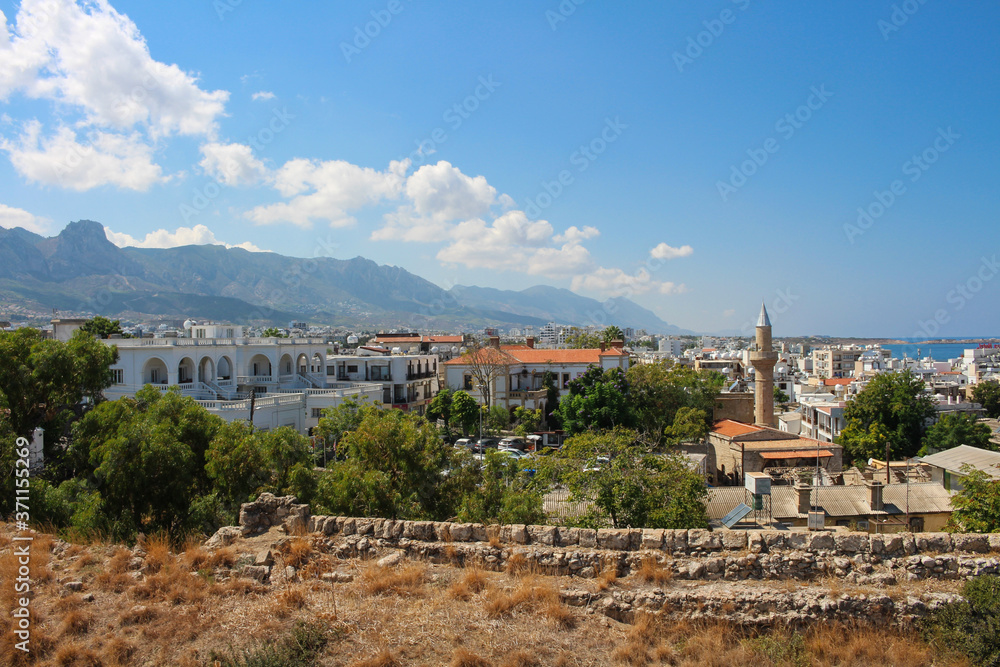 View from the fortress wall of the city of Kyrenia on the mountains, houses and a mosque with a minaret. Kyrenia. Cyprus...