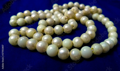 pearl necklace on blue background