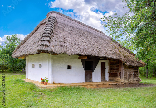 Traditional thatched-roofed rural house .
