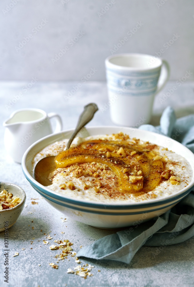 Delicious oat porridge with caramelized banana and nuts for a breakfast. Delicious oat porridge with caramelized banana and nuts for a breakfast.