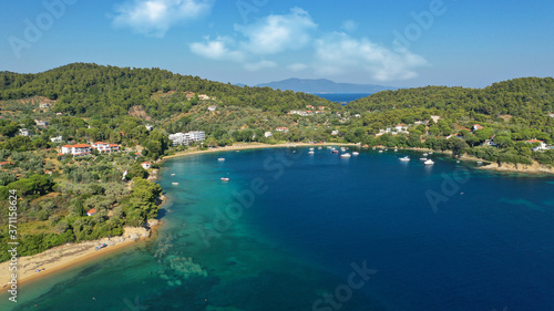 Aerial drone photo of famous organised with sun beds and umbrellas sandy beach of Agia Paraskevi in island of Skiathos  Sporades  Greece