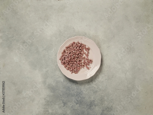 nuts in the plate and up concept, marble grey background.