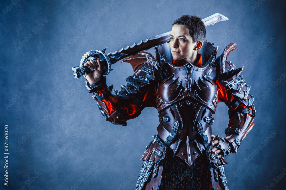 Portrait of a medieval female knight in armour over blue background. Portrait of a medieval female knight in armour over blue background.