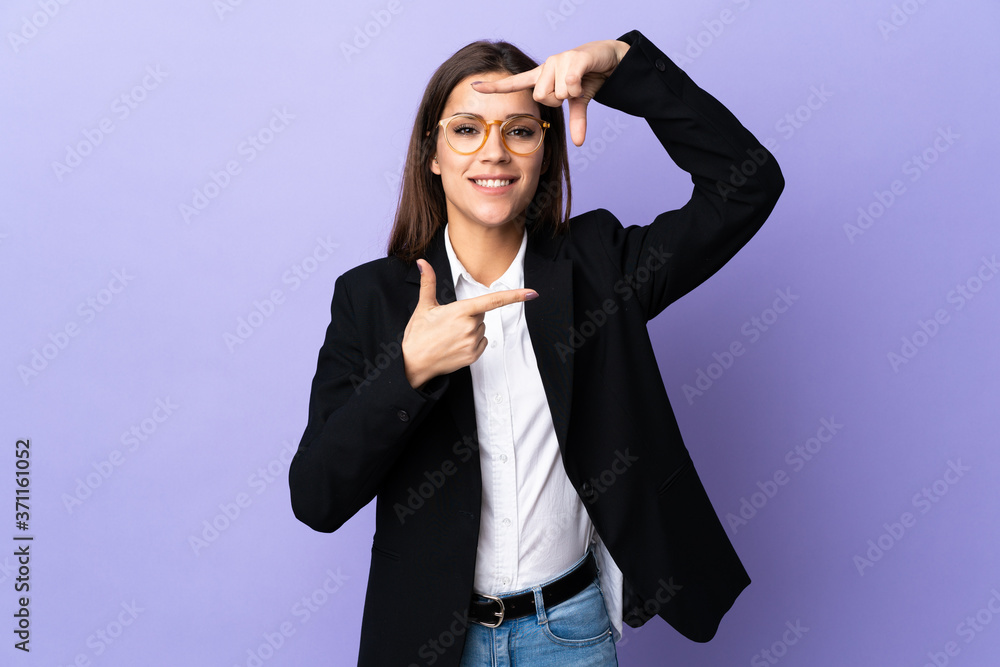 Business woman isolated on purple background focusing face. Framing symbol Business woman isolated on purple background focusing face. Framing symbol