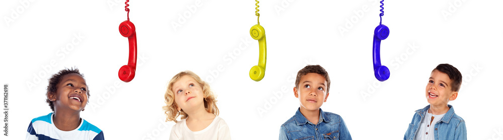 Pensive children looking at coloured hanged phones Pensive children looking at coloured hanged phones