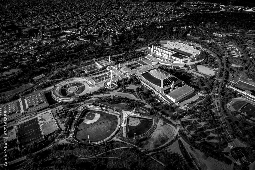 Aerial view of typical buildings of Barcelona cityscape from helicopter.olympic pavilions in Montjuic mountain in black and white. fine art