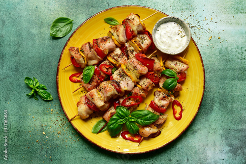 Grilled chicken kebab with vegetable and yogurt sauce. Top view with copy space.