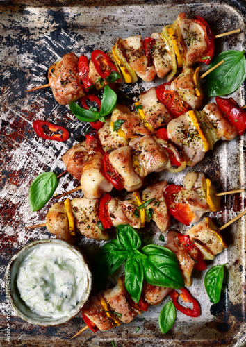 Roasted chicken kebab on a metal baking sheet. Top view with copy space.