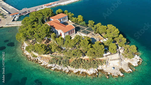 Aerial drone panoramic photo of picturesque main town of Skiathos island featuring small landmark peninsula of Bourtzi, Sporades, Greece