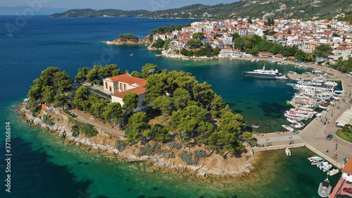 Aerial drone photo of amazing vegetated islet of Bourtzi built in small peninsula in port of Skiathos island main town hosting an old school, Sporades, Greece