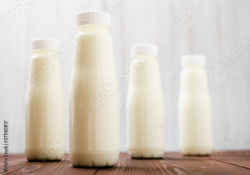 Bottles with milk  yogurt on a light background. Natural dairy products.
