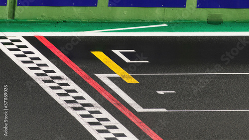 The finish line of a racing track with the number one written on the asphalt , symbol of the goal to reach